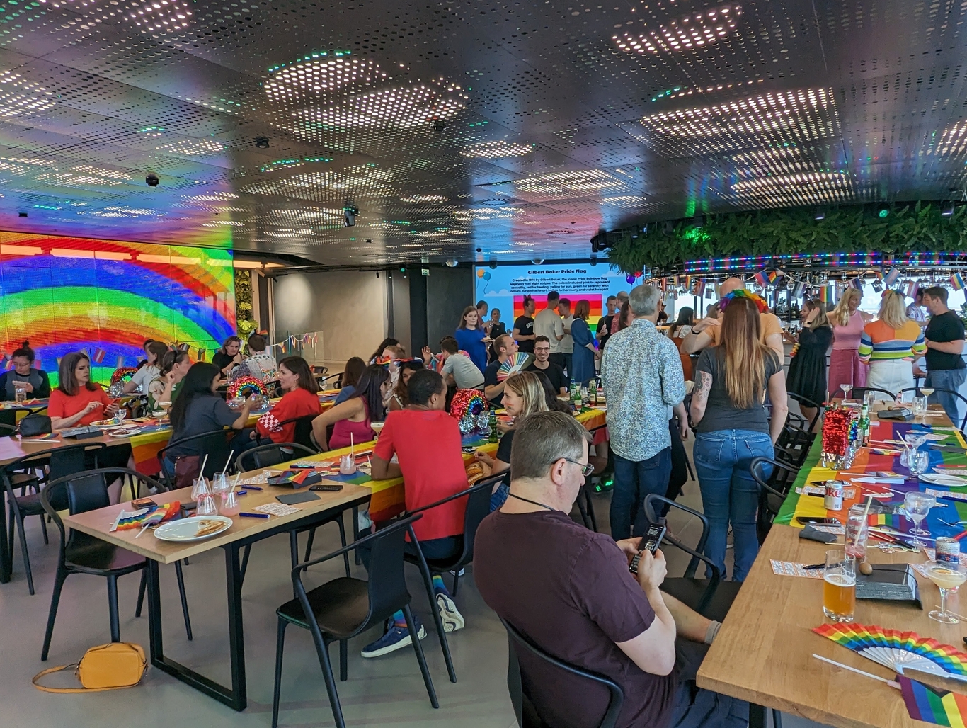 Pride social in breakout area with everyone in the breakout space talking and socialising