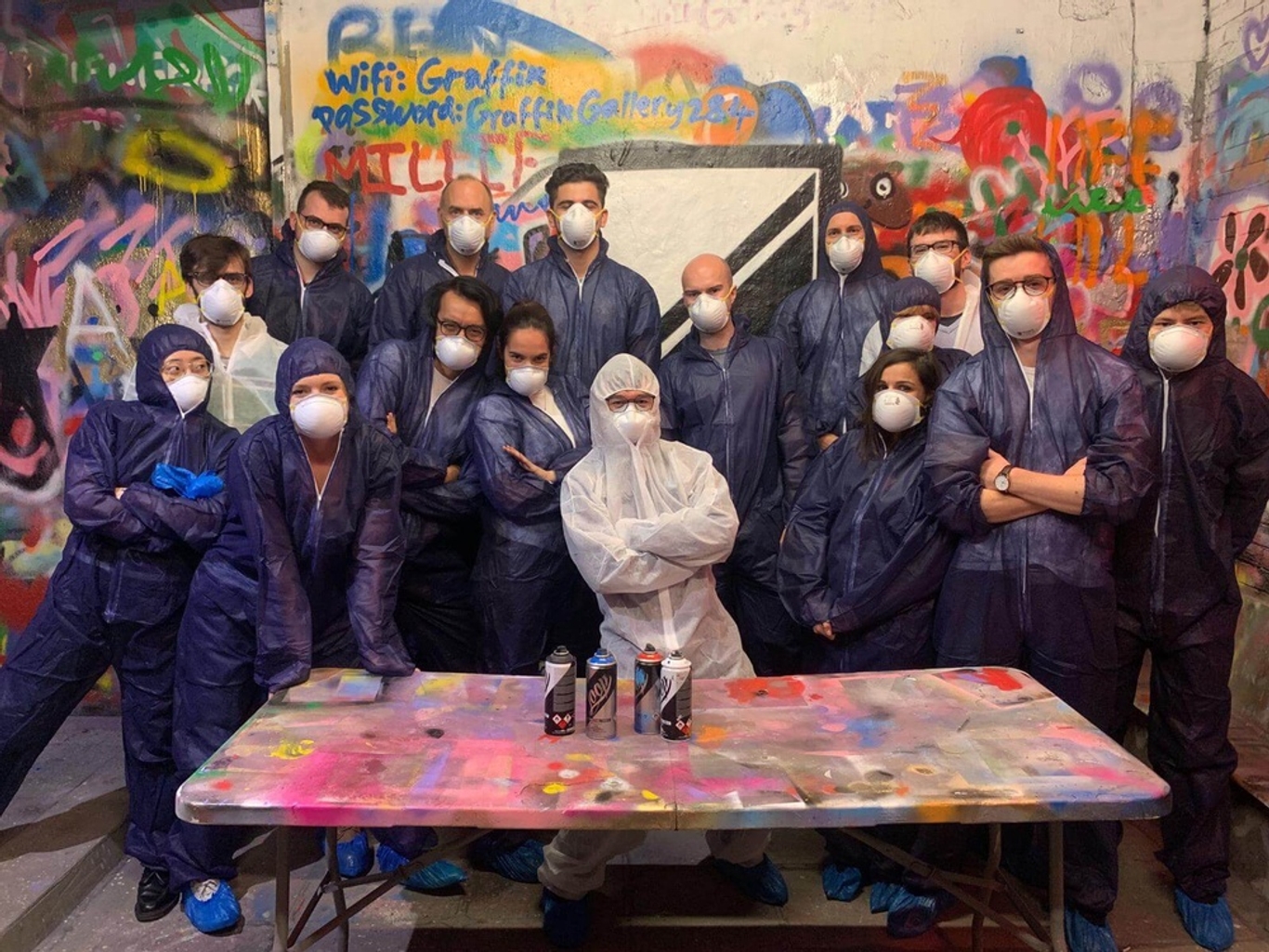 Quadrature team posing in body suits at a spray painting event